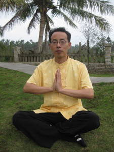 Zou Ping prayer hands under Palm Tree in Hainan